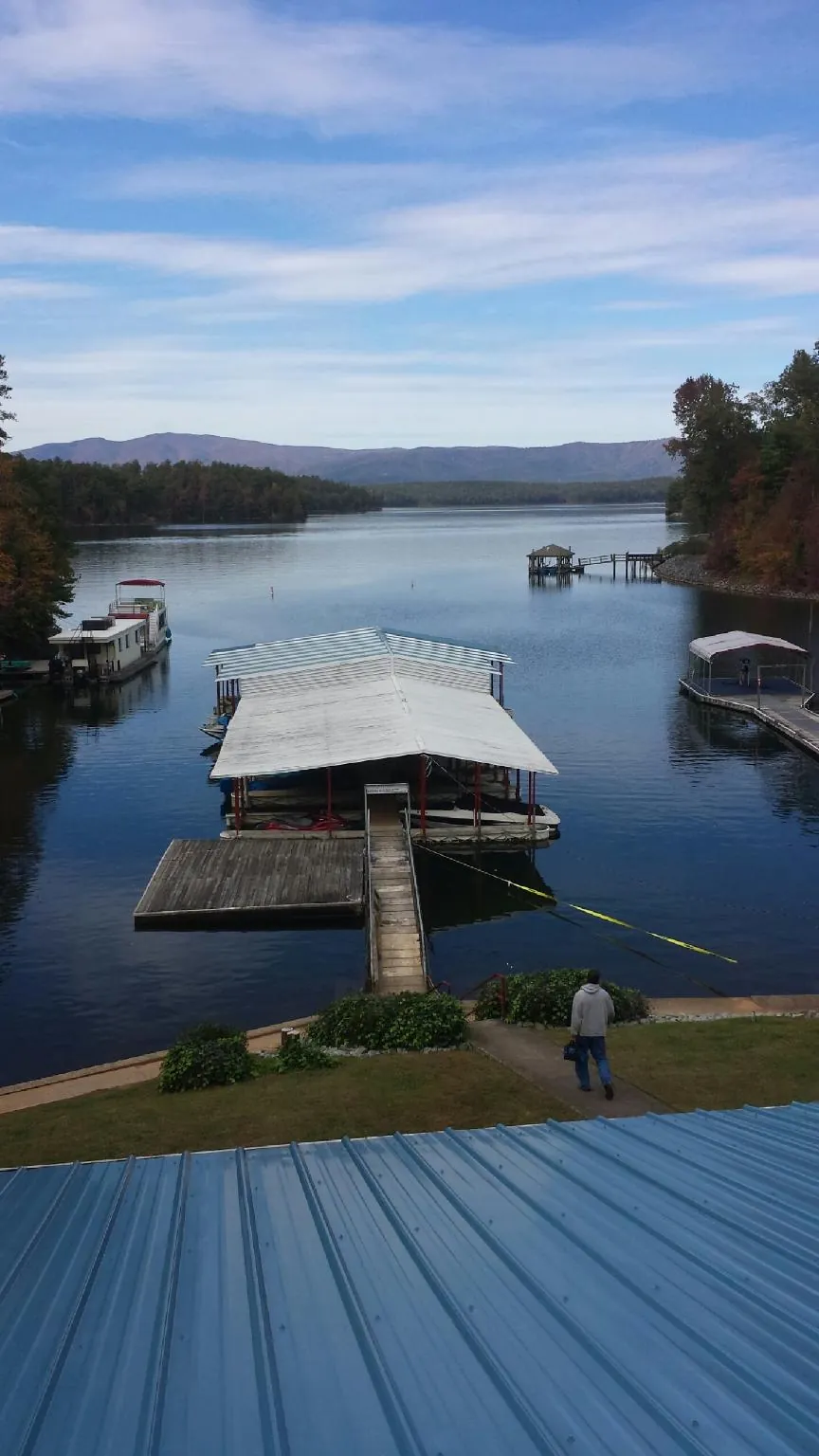 View across a lake from a newly installed blue metal roof in East Stroudsburg