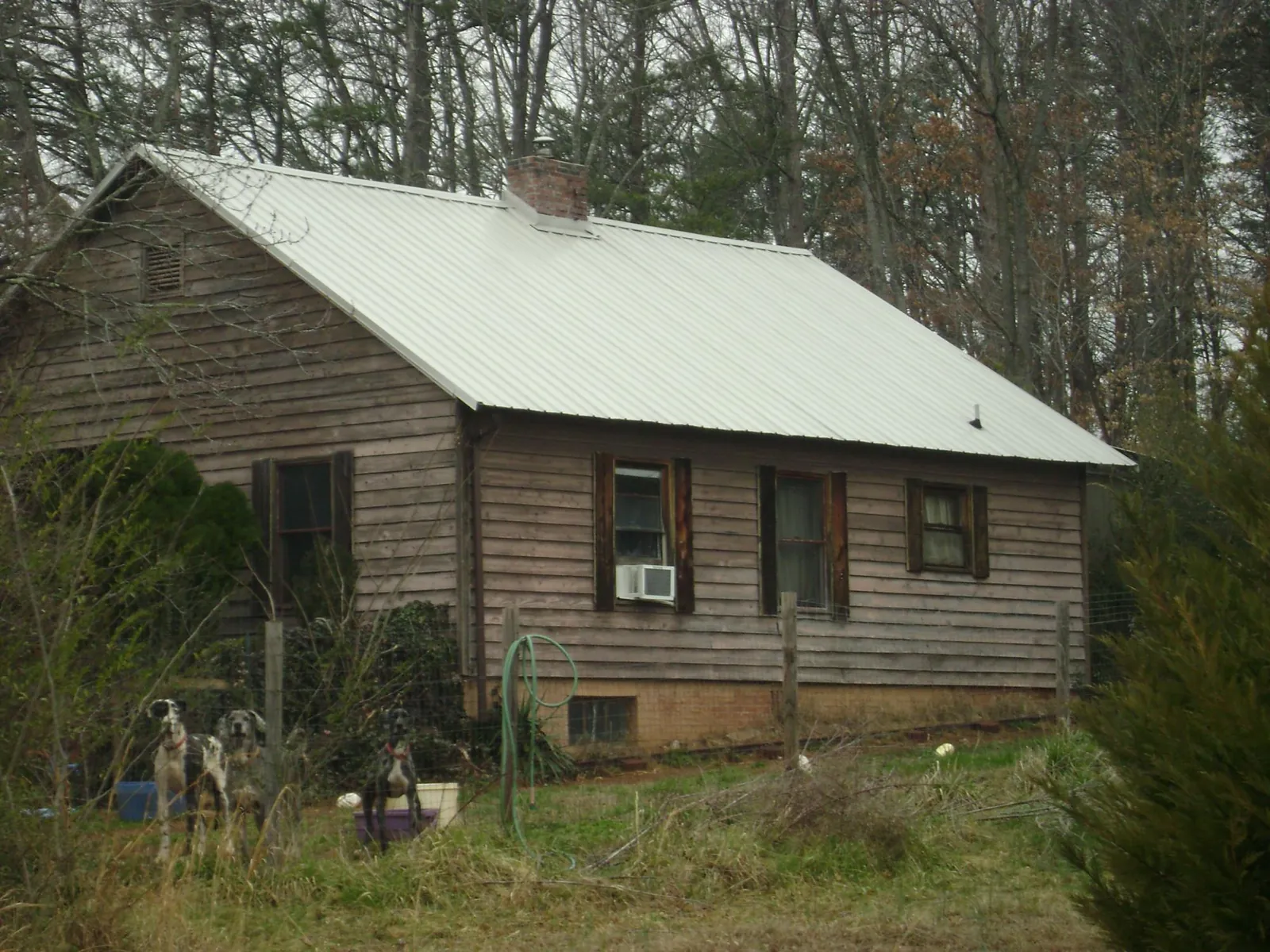 White metal roof on an old wood sided farmhouse, from a Asphalt Shingle Roof Repair job in East Stroudsburg